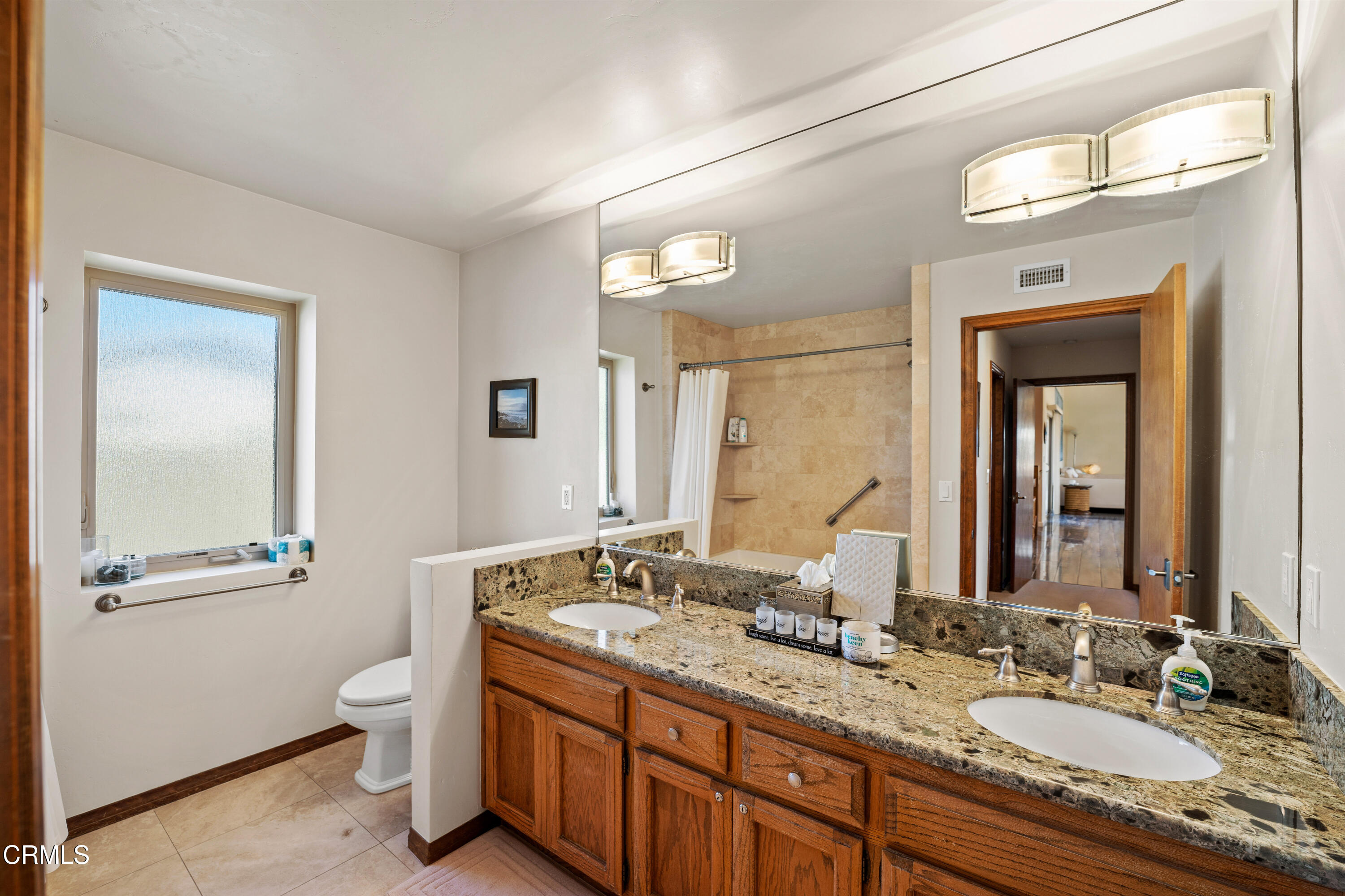 1150 Mandalay Beach Road Oxnard, CA 93035 - Photo 22 of 48 a bathroom with a granite countertop sink toilet and mirror