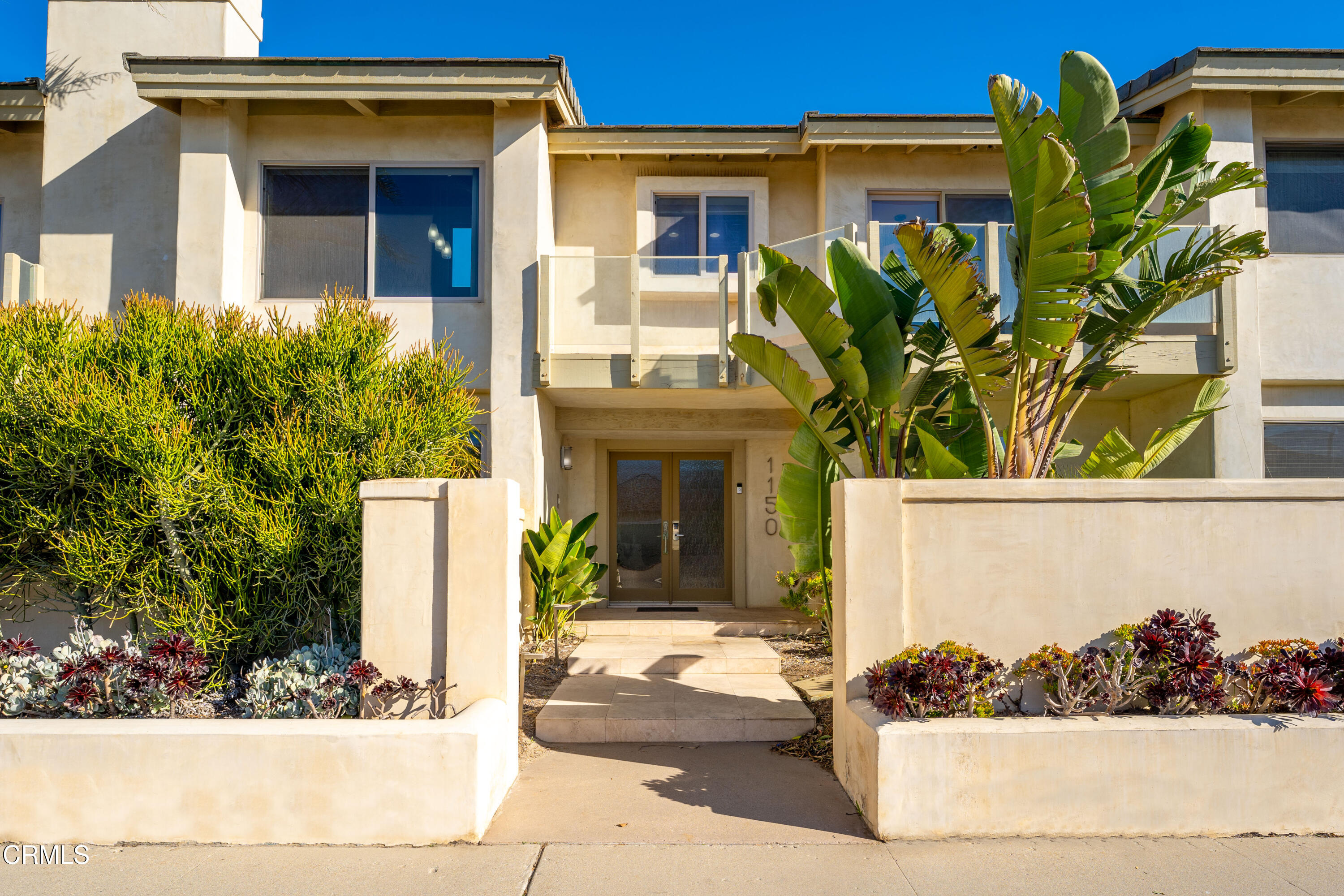 1150 Mandalay Beach Road Oxnard, CA 93035 - Photo 43 of 48 a front view of a house with a garden