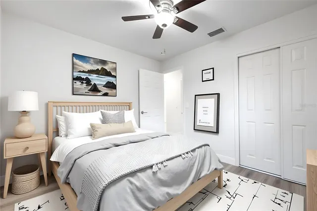 a bedroom with a bed and a painting on the wall