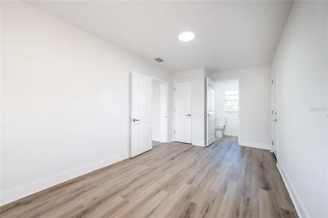a view of a room with wooden floor