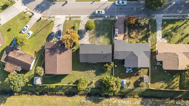 an aerial view of residential houses with outdoor space