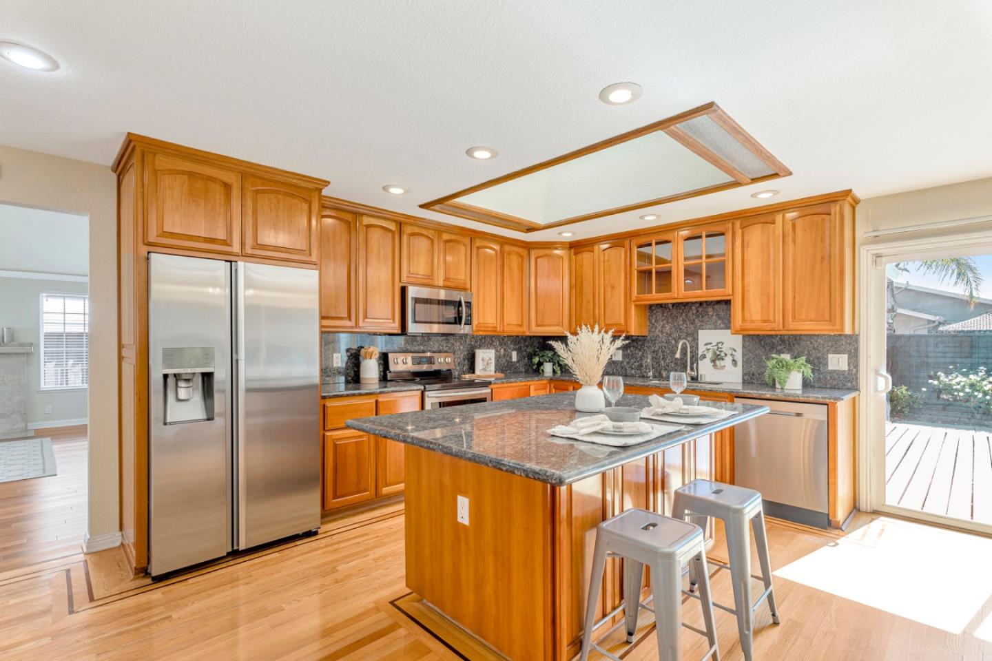 4692 Mia Circle San Jose, CA 95136 - Photo 13 of 42 a kitchen with stainless steel appliances granite countertop a refrigerator a stove and a sink with granite countertops
