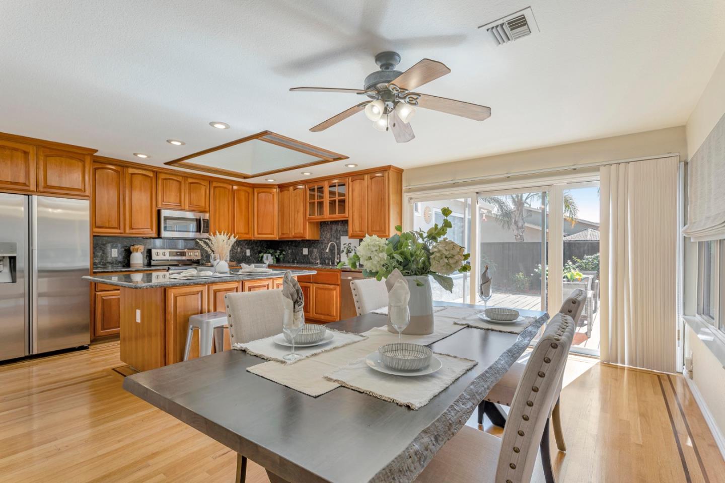 4692 Mia Circle San Jose, CA 95136 - Photo 14 of 42 a view of a dining room with furniture a chandelier and wooden floor