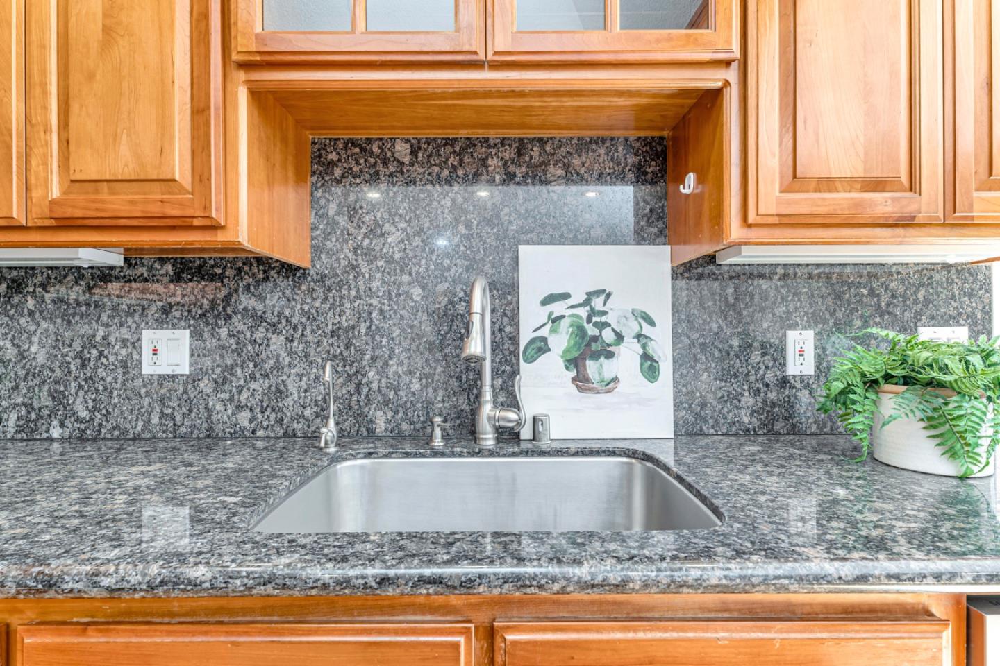 4692 Mia Circle San Jose, CA 95136 - Photo 17 of 42 a kitchen sink with granite counter tops and a window