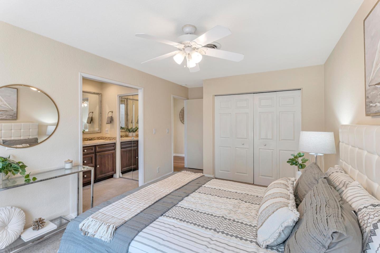 4692 Mia Circle San Jose, CA 95136 - Photo 25 of 42 a bedroom with a bed and a chandelier