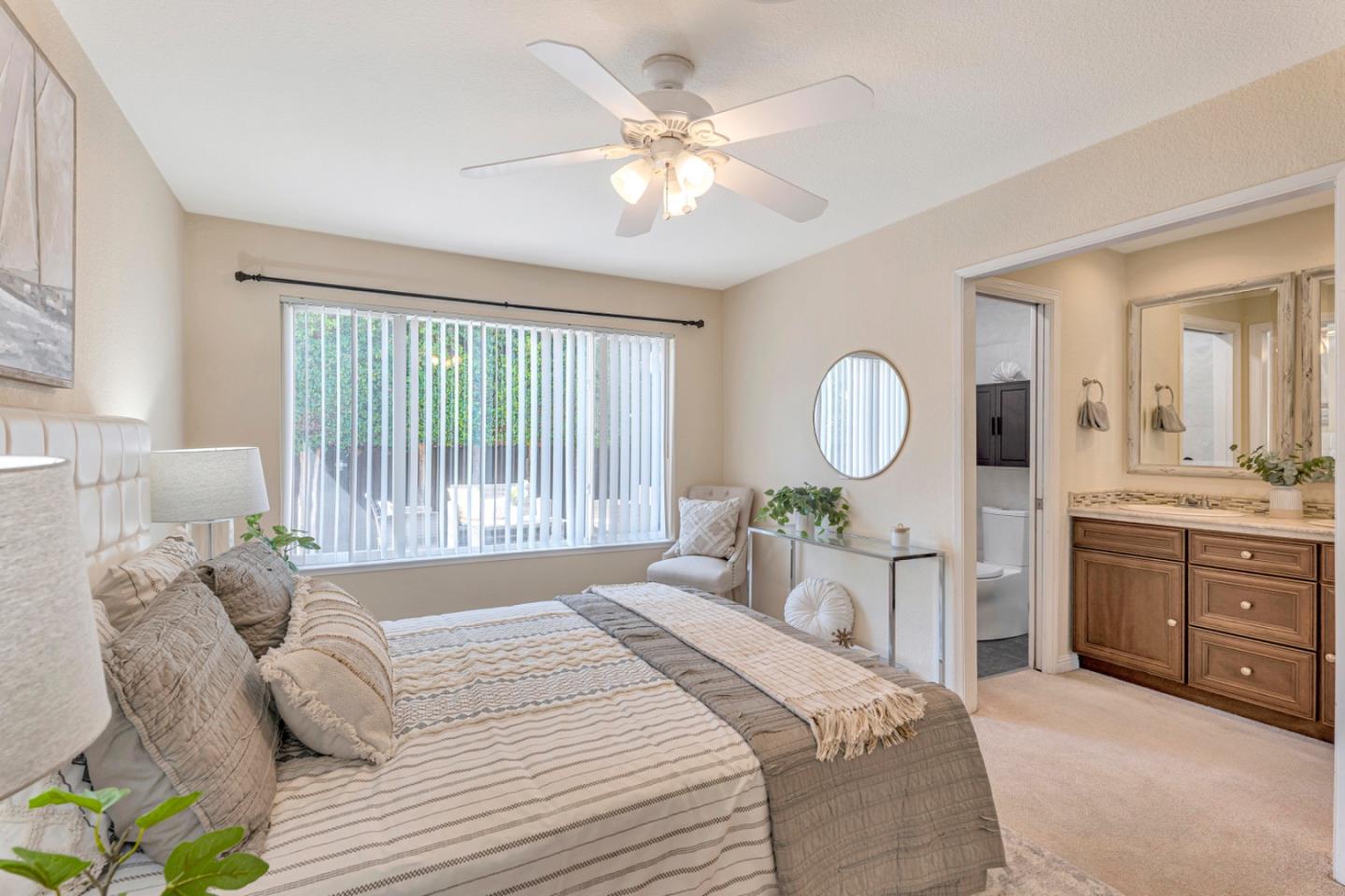 4692 Mia Circle San Jose, CA 95136 - Photo 26 of 42 a spacious bedroom with a large bed and a chandelier