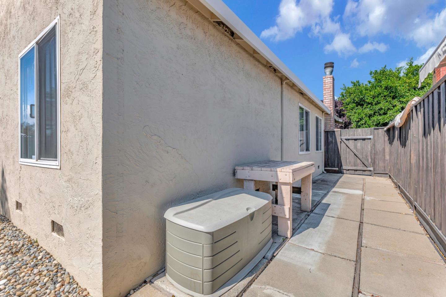 4692 Mia Circle San Jose, CA 95136 - Photo 42 of 42 a view of a patio with table and chairs with wooden fence and plants