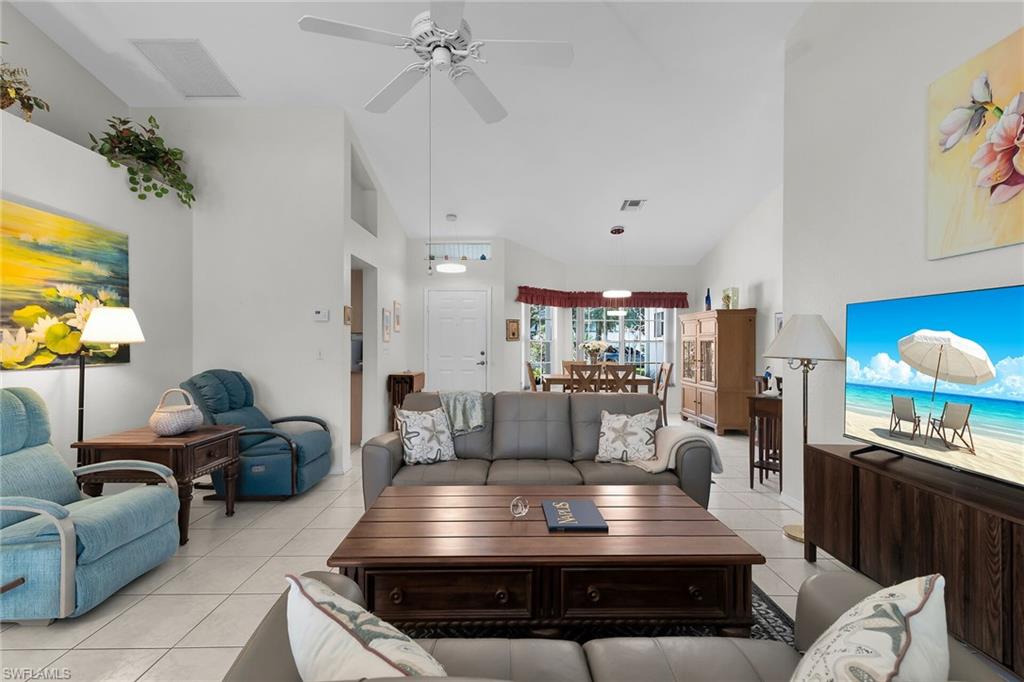 443 Dundee Court Naples, FL 34104 - Photo 17 of 39 a living room with furniture and a flat screen tv