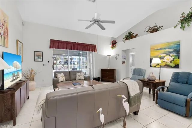 a living room with fireplace furniture and a flat screen tv