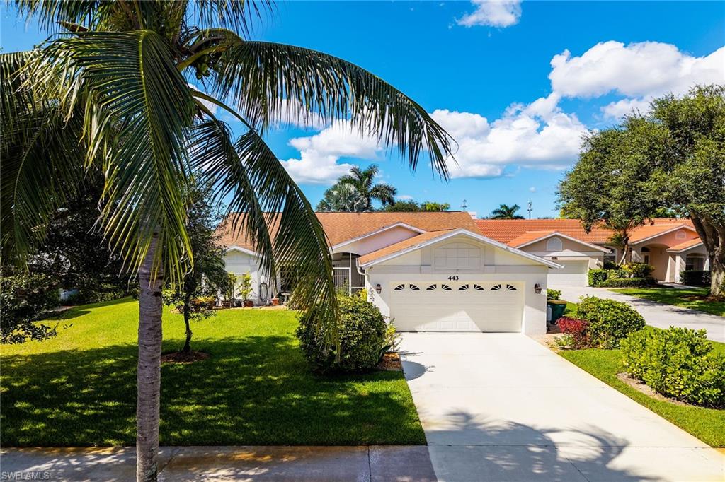 443 Dundee Court Naples, FL 34104 - Photo 2 of 39 a front view of a house with a yard