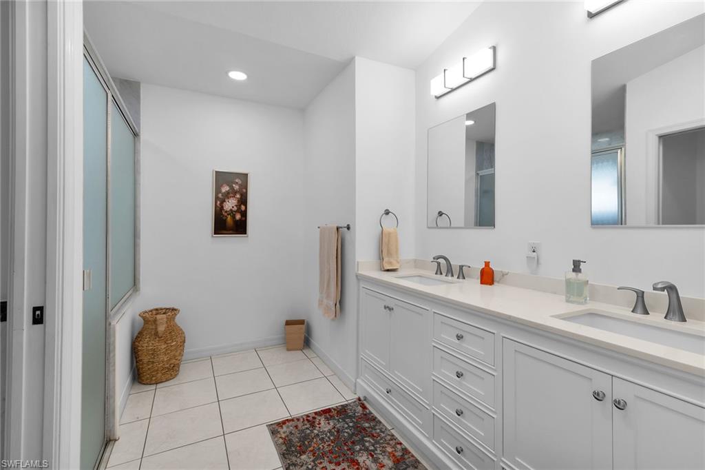 443 Dundee Court Naples, FL 34104 - Photo 29 of 39 a bathroom with a sink and a mirror