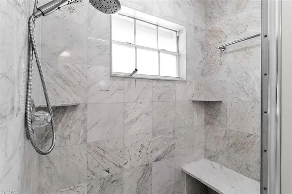 a bathroom with a glass shower door