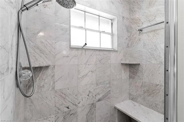 a bathroom with a glass shower door