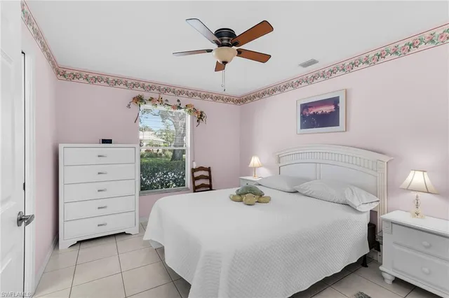 a bedroom with a bed and a ceiling fan