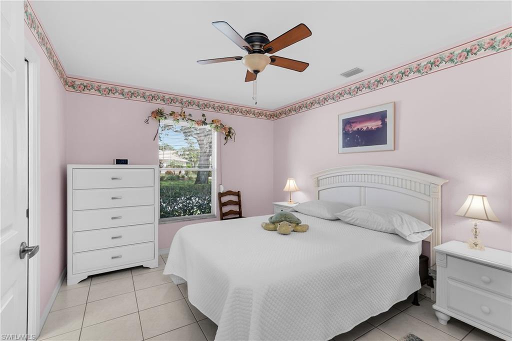 443 Dundee Court Naples, FL 34104 - Photo 31 of 39 a bedroom with a bed and a ceiling fan