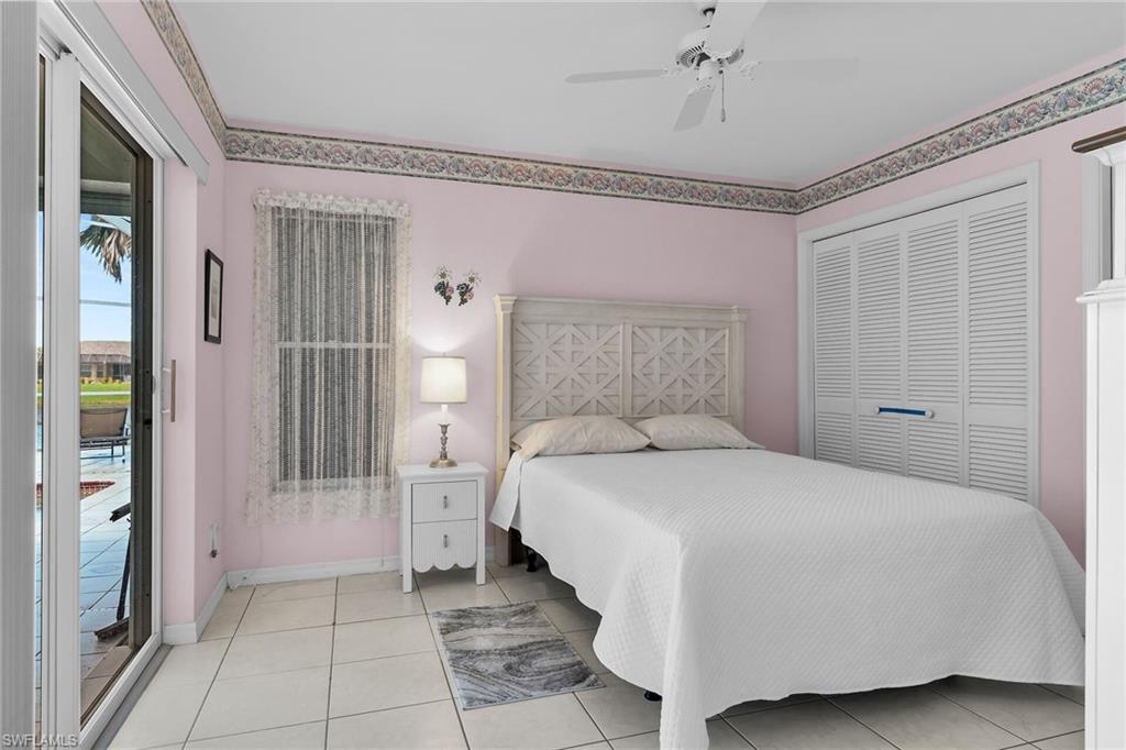 443 Dundee Court Naples, FL 34104 - Photo 33 of 39 a bedroom with a bed and a window