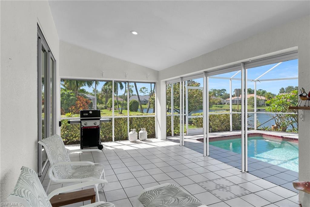 443 Dundee Court Naples, FL 34104 - Photo 35 of 39 a view of a living room and floor to ceiling window