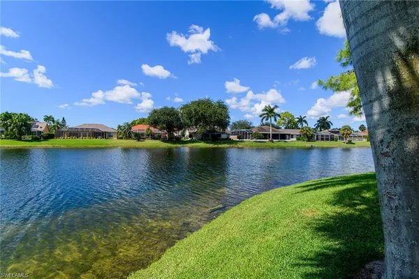a view of a lake with houses in the back
