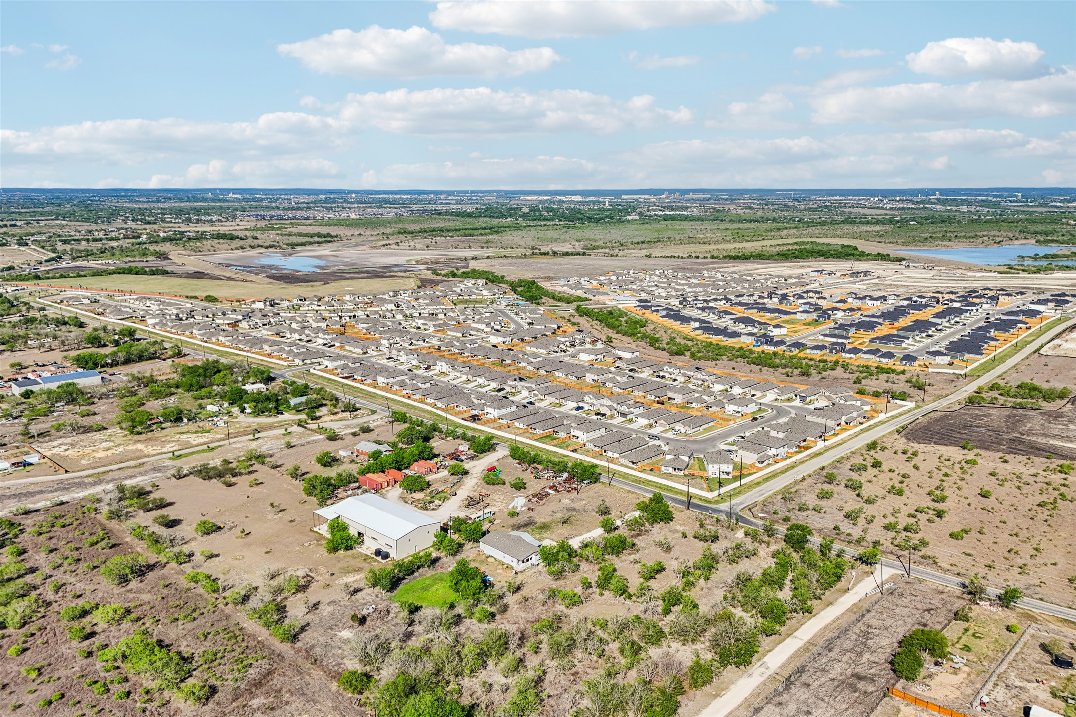 754 Williamson Road, Unit B Niederwald, TX 78640 - Photo 2 of 14 Aerial perspective of suburban area with a large body of water