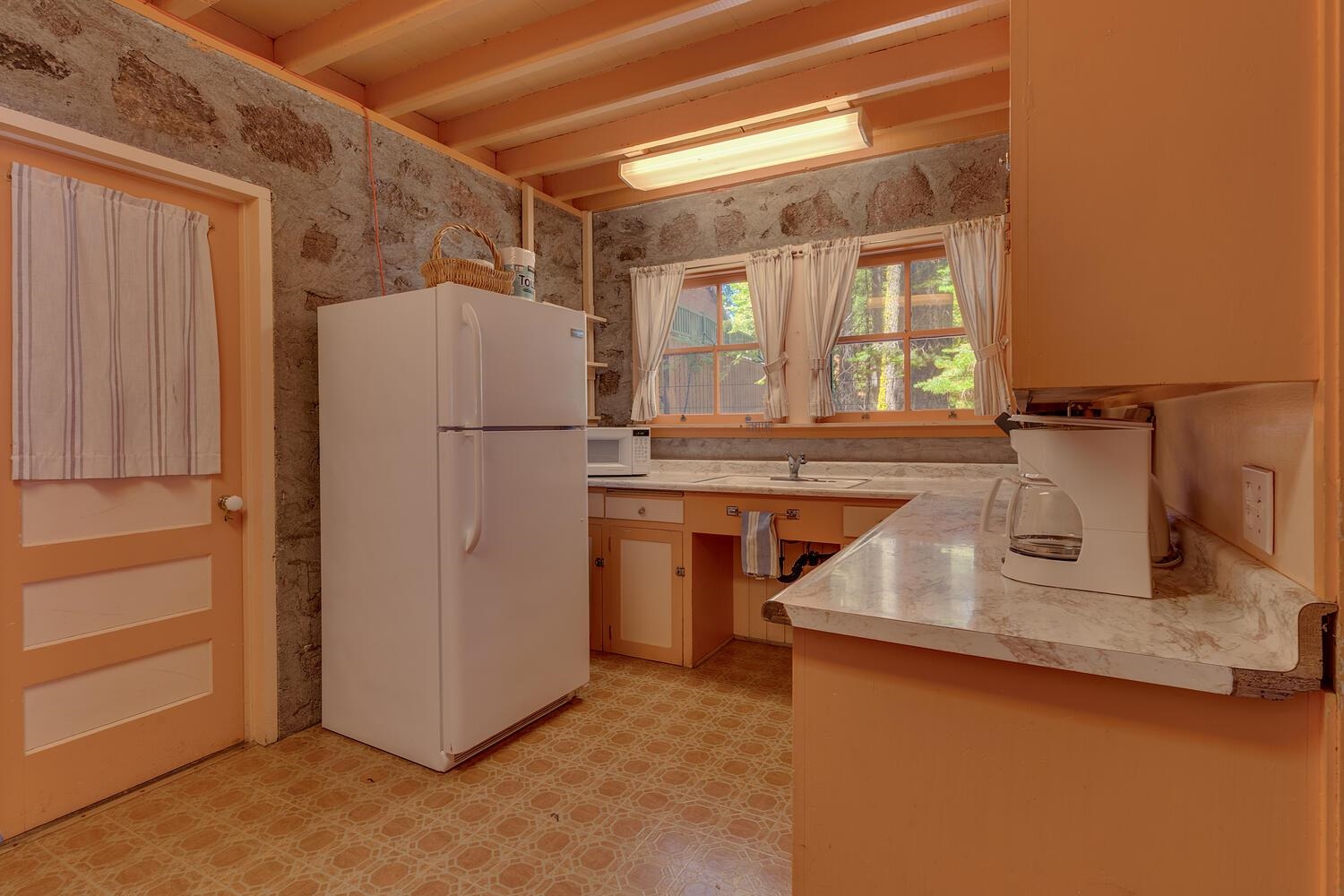 4715 Cedar Homewood, CA 96141 - Photo 13 of 25 a kitchen with stainless steel appliances granite countertop a refrigerator a stove and a sink with large cabinets