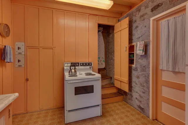 a view of a patio with a table and chairs under an umbrella
