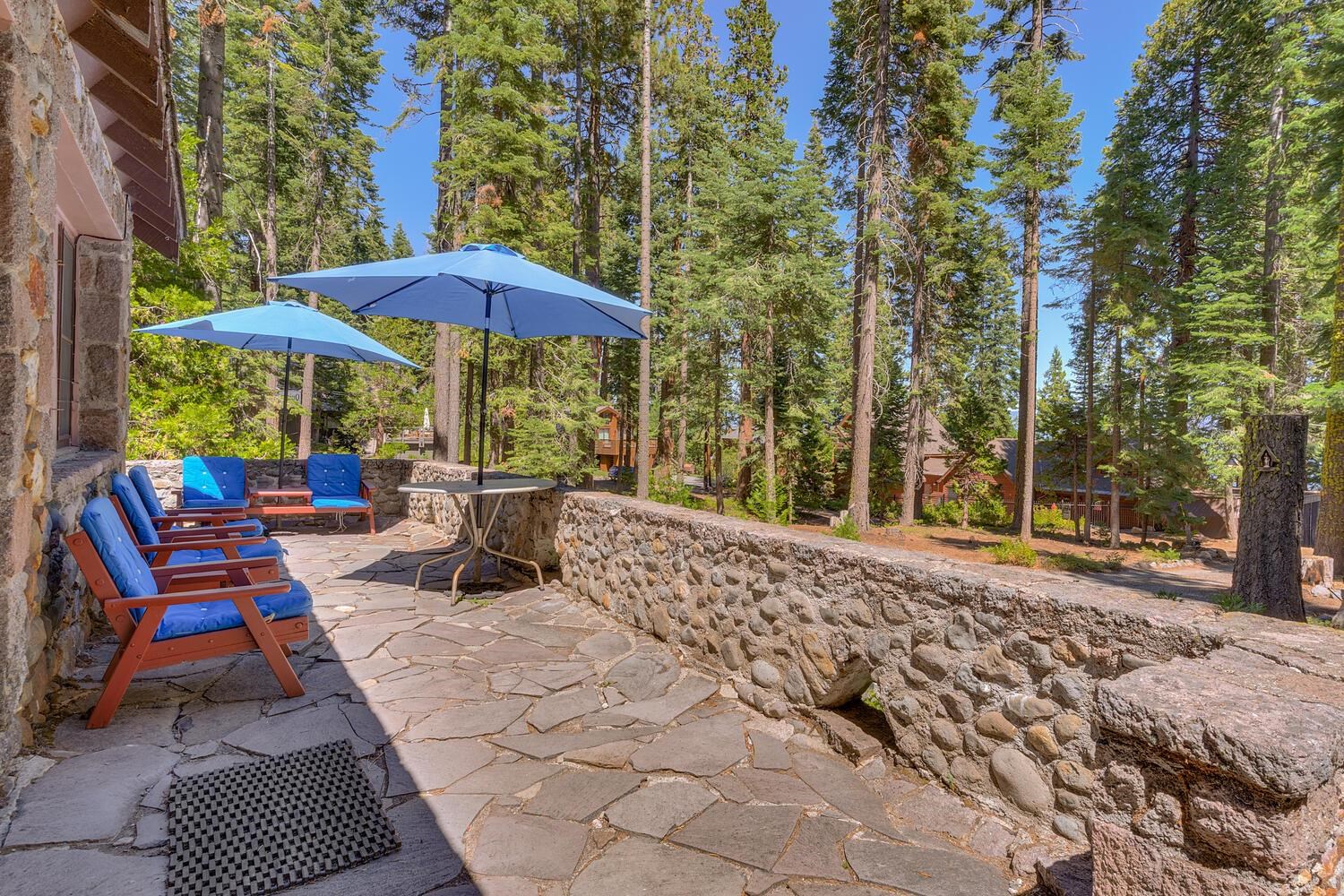 4715 Cedar Homewood, CA 96141 - Photo 15 of 25 a view of a patio with a table and chairs under an umbrella