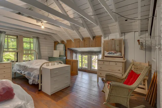 a bedroom with a bed next to a window