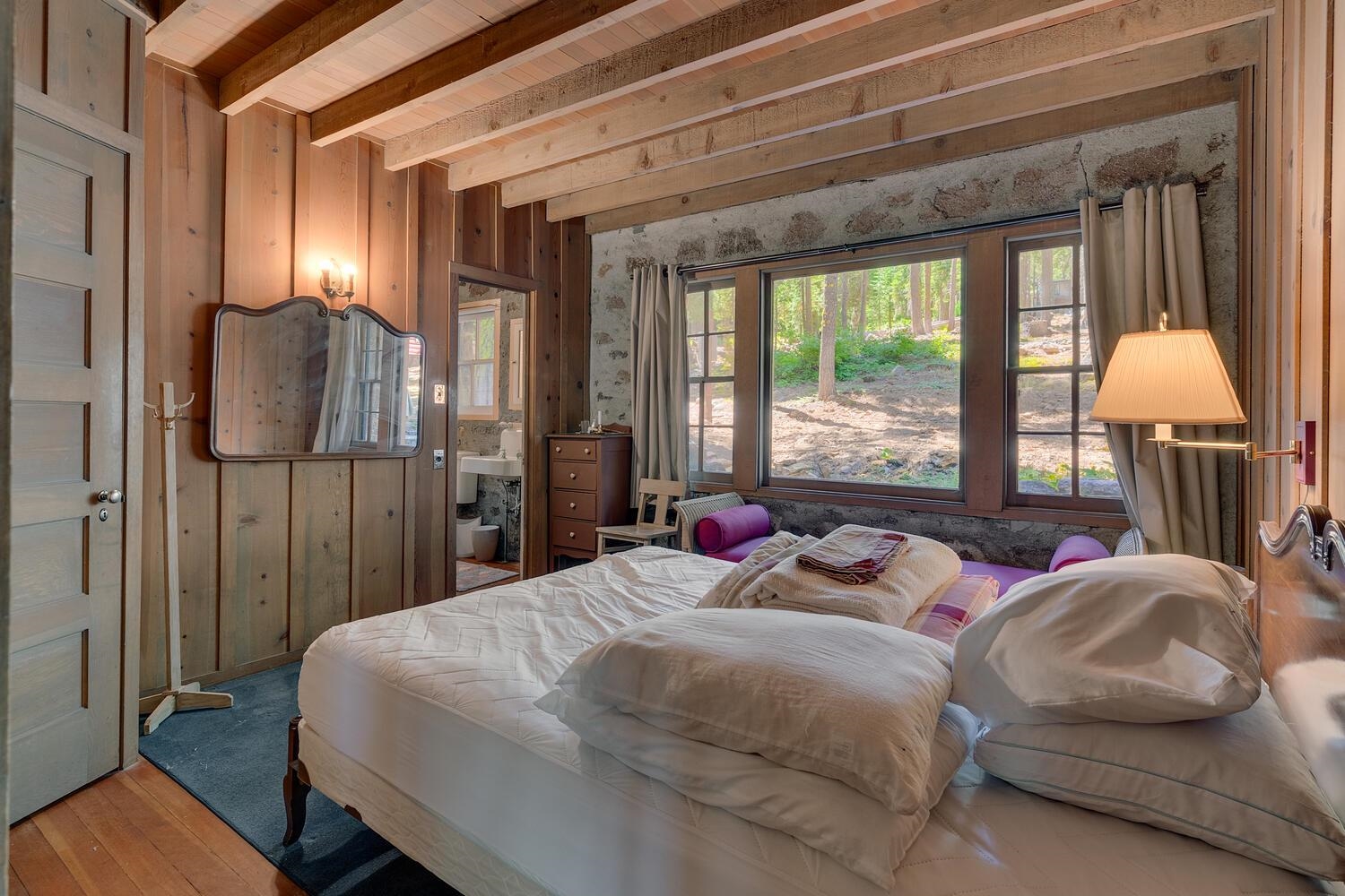 4715 Cedar Homewood, CA 96141 - Photo 18 of 25 a bedroom with a bed mirror and window