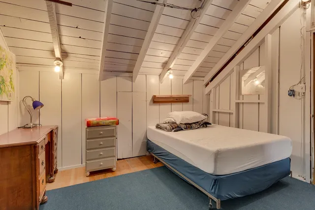 a bedroom with furniture and flat screen tv