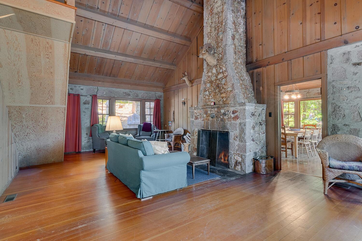 4715 Cedar Homewood, CA 96141 - Photo 7 of 25 a living room with furniture a fireplace and a chandelier