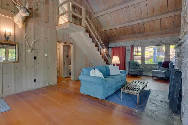 a living room with furniture and stairs