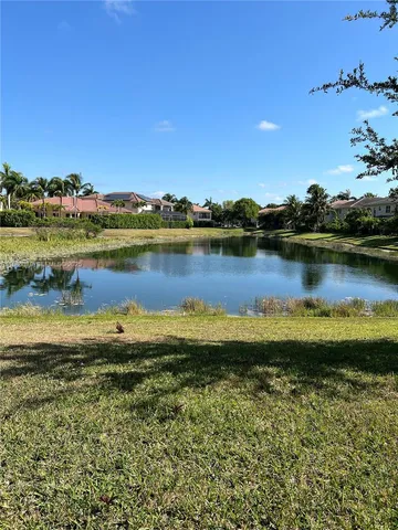 a view of a lake with houses in the back