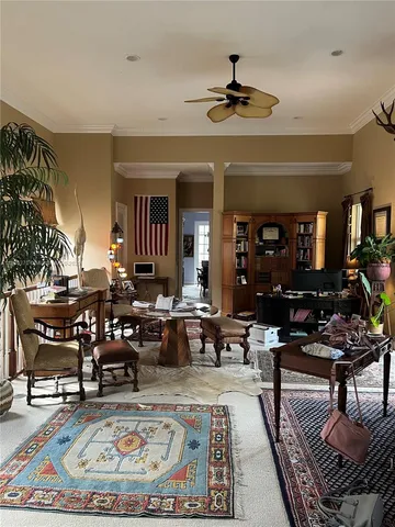 a living room with fireplace furniture and a rug