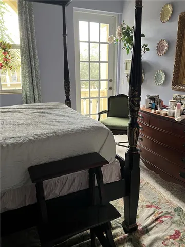 a bedroom with a bed window and table