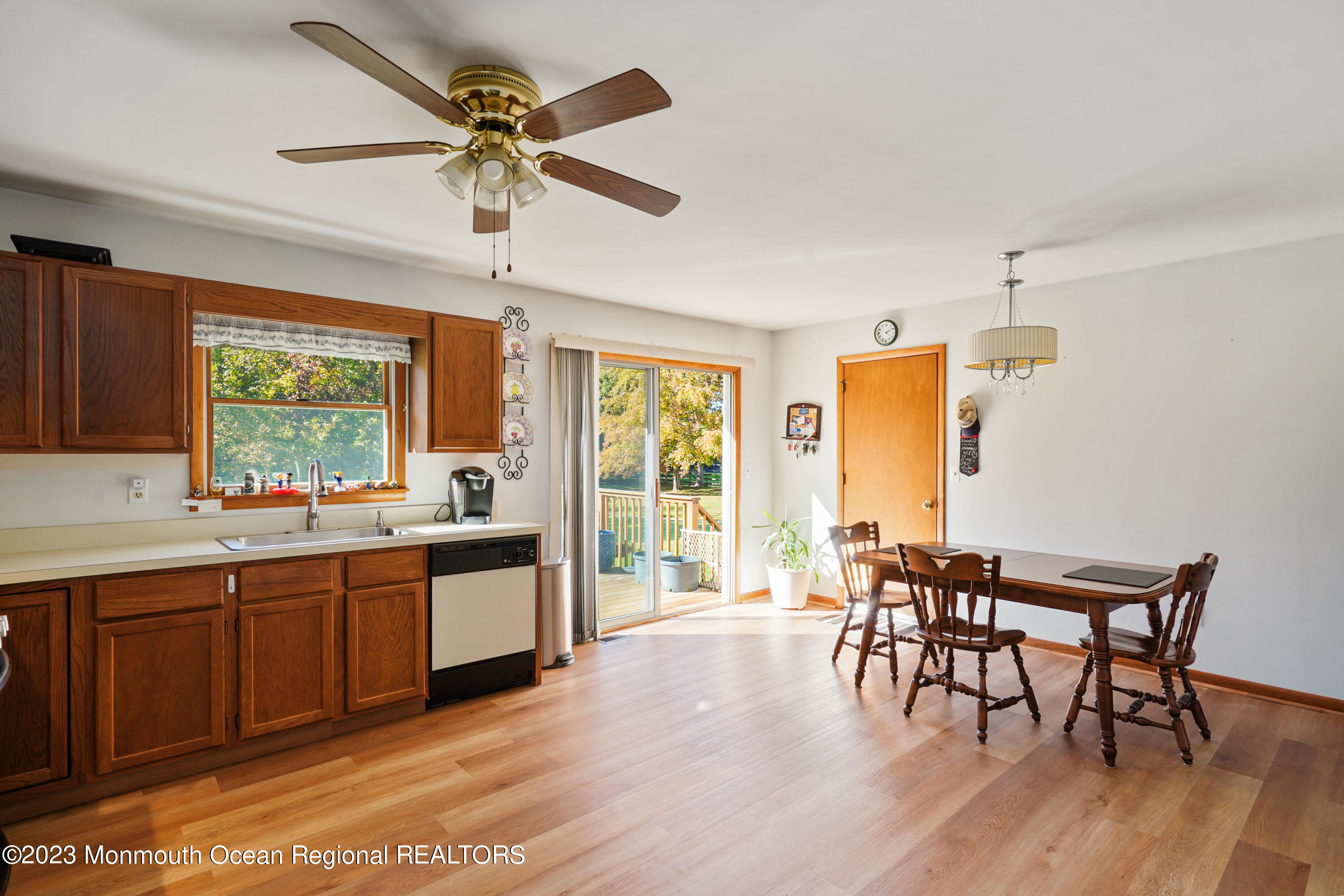 222 Leesville Road Jackson, NJ 08527 - Photo 17 of 61 a kitchen with stainless steel appliances a dining table chairs and wooden floor