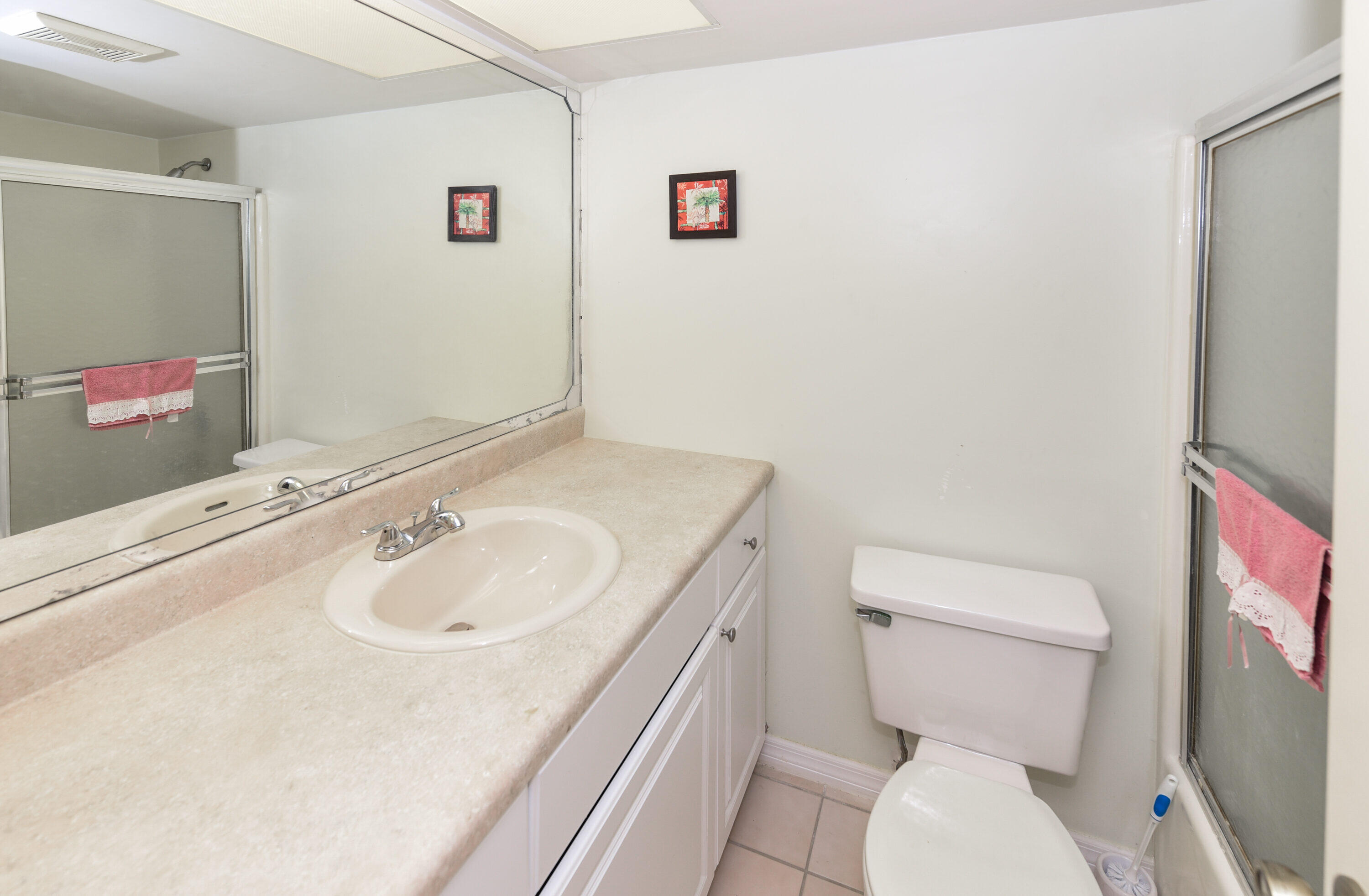 1871 Southwest Palm City Road, Unit G201 Stuart, FL 34994 - Photo 15 of 25 a bathroom with a sink a toilet and a mirror