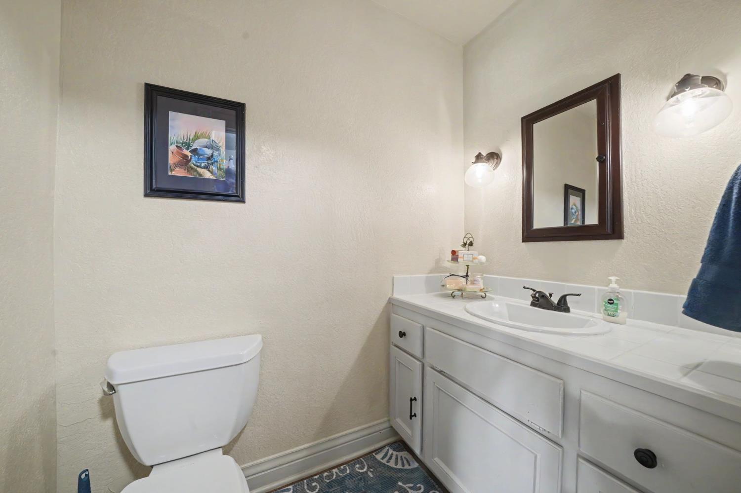 519 Clinton Road Jackson, CA 95642 - Photo 17 of 80 a bathroom with a toilet a sink and mirror