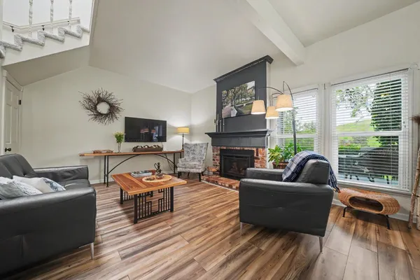 a bedroom with furniture and a wooden floor