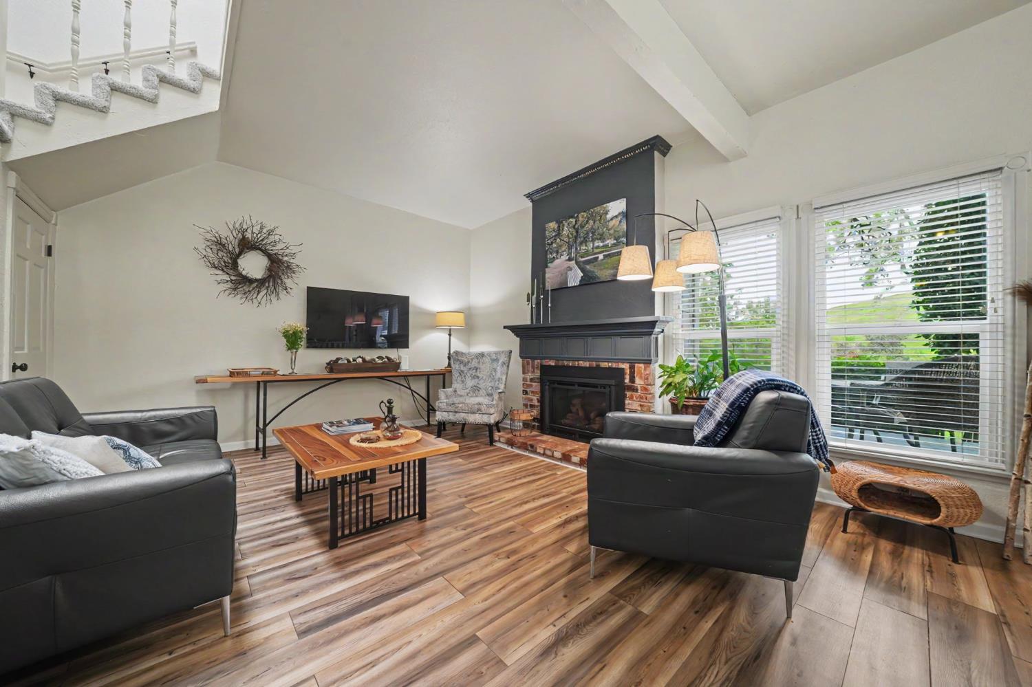 519 Clinton Road Jackson, CA 95642 - Photo 25 of 80 a living room with furniture a fireplace and a flat screen tv