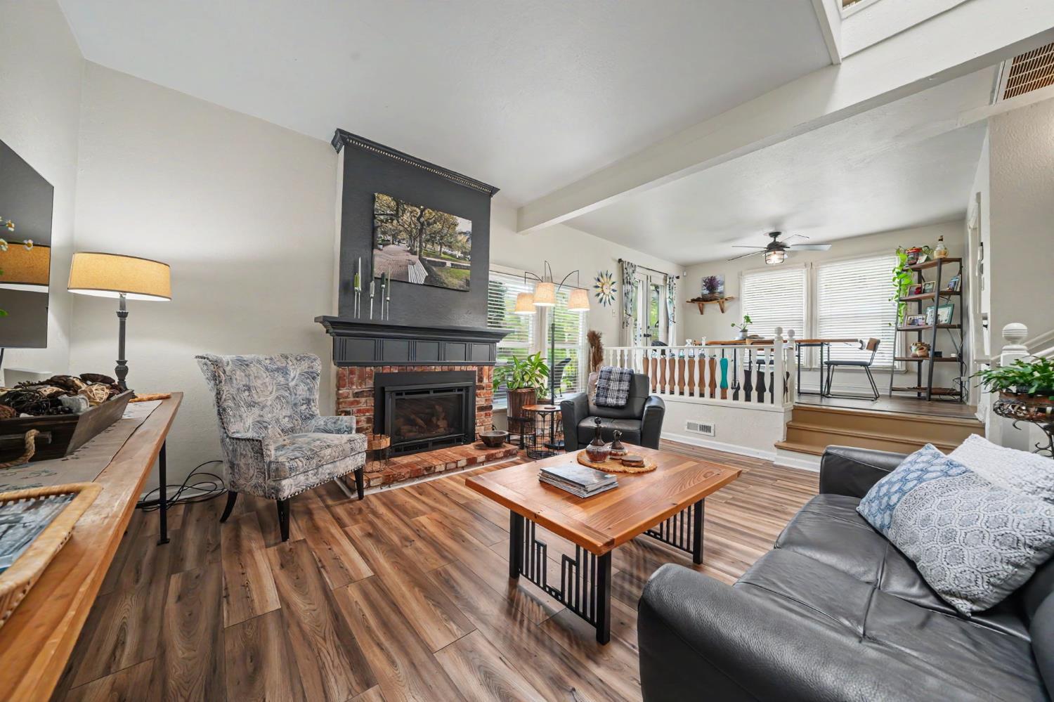 519 Clinton Road Jackson, CA 95642 - Photo 29 of 80 a living room with fireplace furniture and a wooden floor