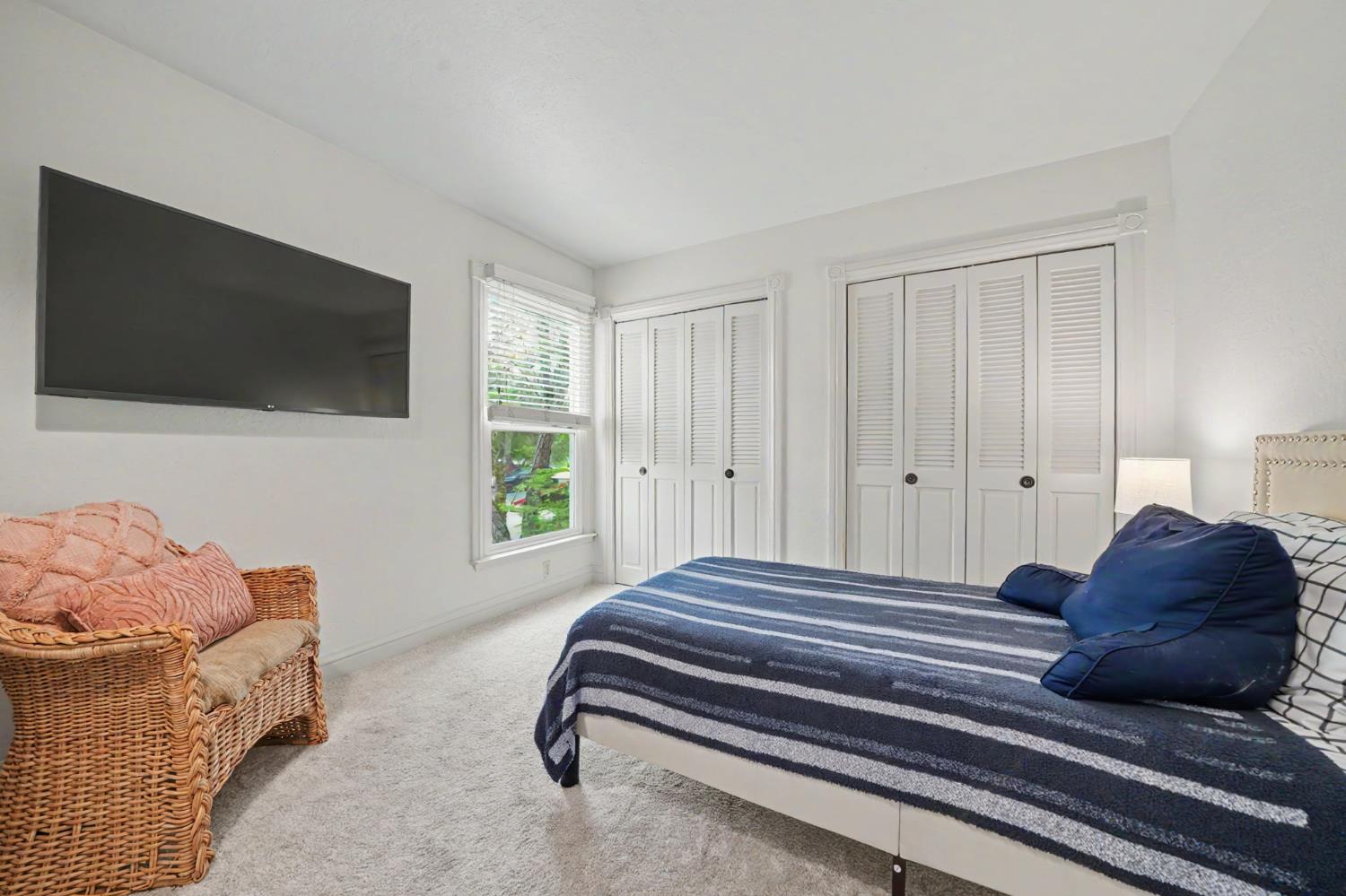 519 Clinton Road Jackson, CA 95642 - Photo 39 of 80 a bedroom with a bed and a flat screen tv