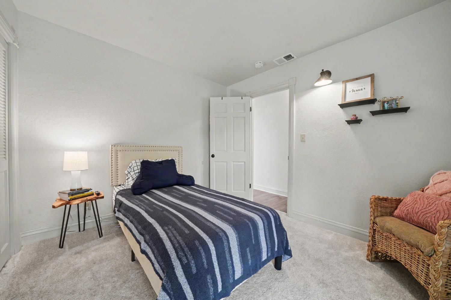 519 Clinton Road Jackson, CA 95642 - Photo 40 of 80 a bedroom with a bed and a chair