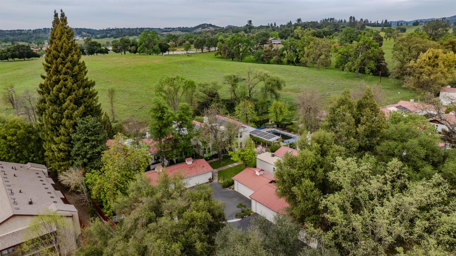 519 Clinton Road Jackson, CA 95642 - Photo 67 of 80 an aerial view of green landscape with trees houses and mountain view