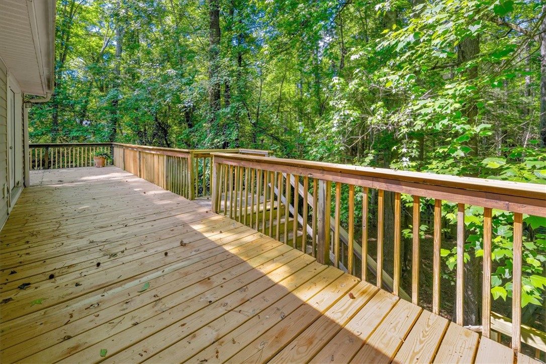 210 Briarcliff Road Central, SC 29630 - Photo 33 of 39 This spacious wooden deck offers a serene outdoor retreat surrounded by lush greenery.