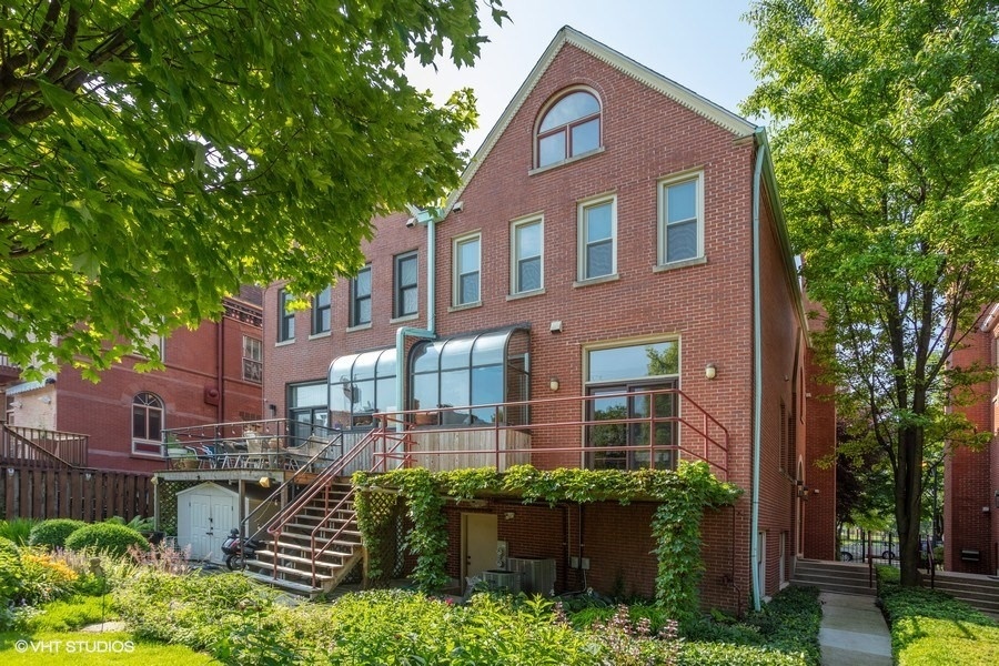 1274 West Lexington Street Chicago, IL 60607 - Photo 23 of 32 a view of a brick building next to a yard