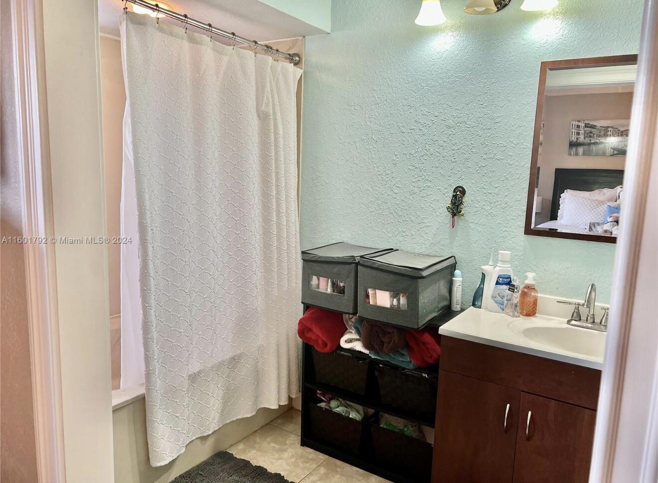 9235 Southwest 8th Street, Unit 507 Boca Raton, FL 33428 - Photo 7 of 16 a bathroom with a sink vanity and a mirror