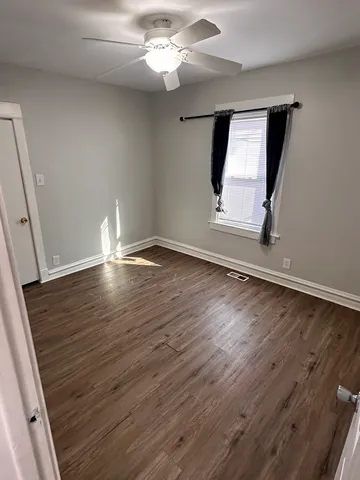 wooden floor in an empty room with a mirror