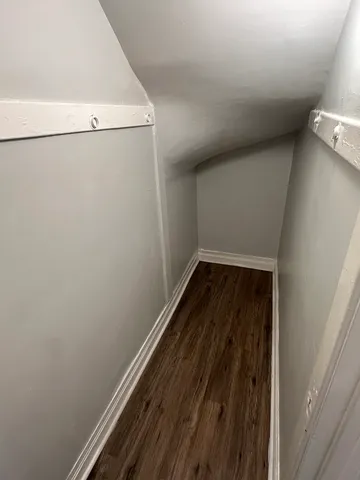 a view of a room with wooden floor