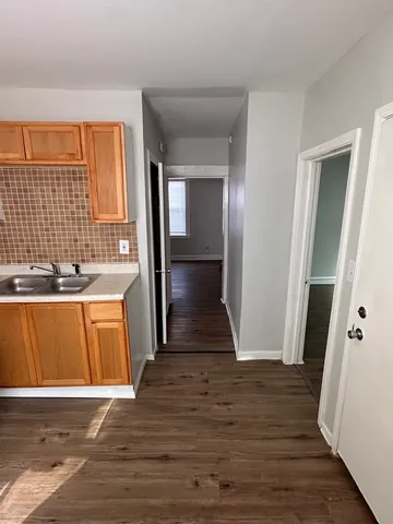 a view of a kitchen from a hallway