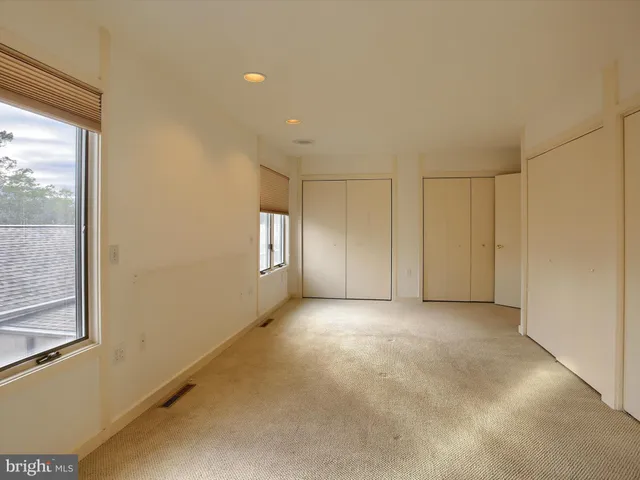 a view of a livingroom with an empty space and a window
